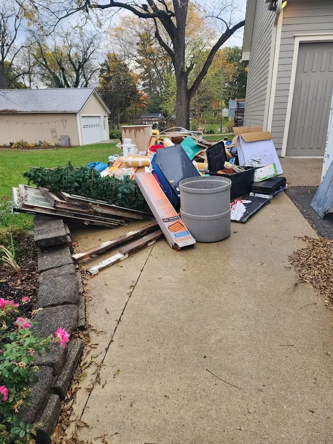 Dumpster being loaded with debris for Estate Cleanout Dumpster Rental in Iowa